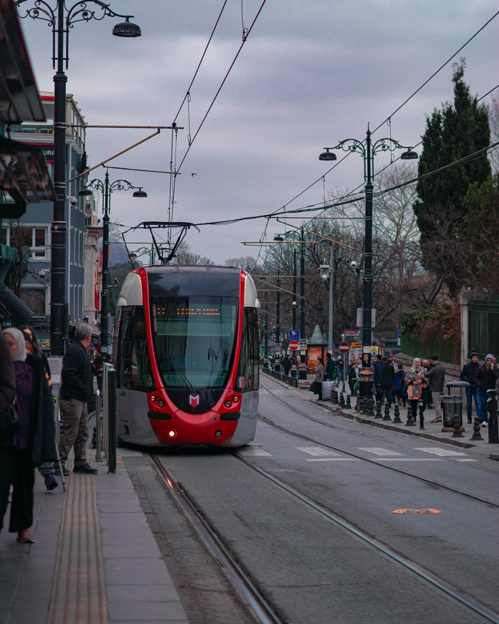 the city bus is coming down the road