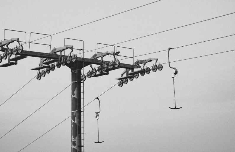 the top of many telephone wires covered in snow