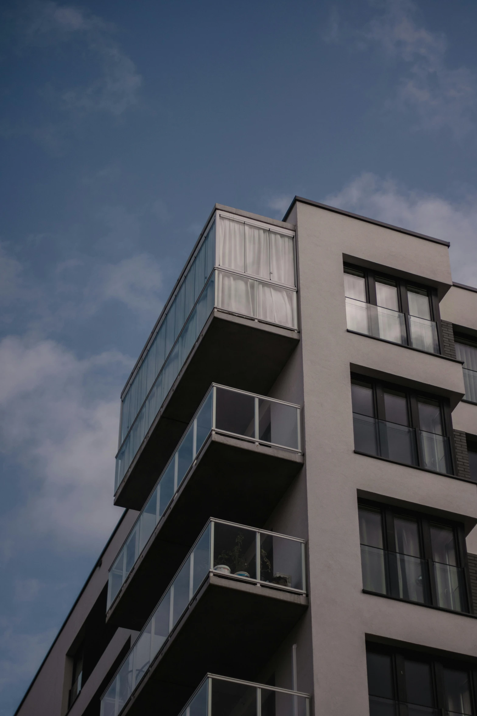 an apartment building with balconies against a blue sky