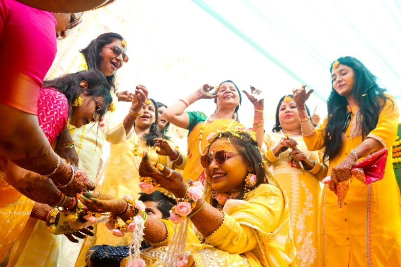 people in bright yellow attire standing together at a wedding