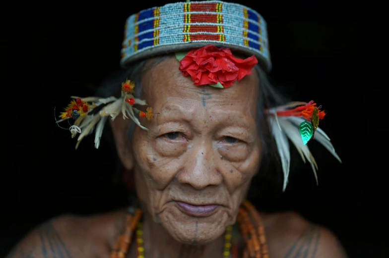 a woman with feathers around her head and eyes