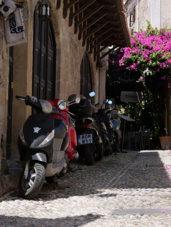 there are several mopeds parked near one another