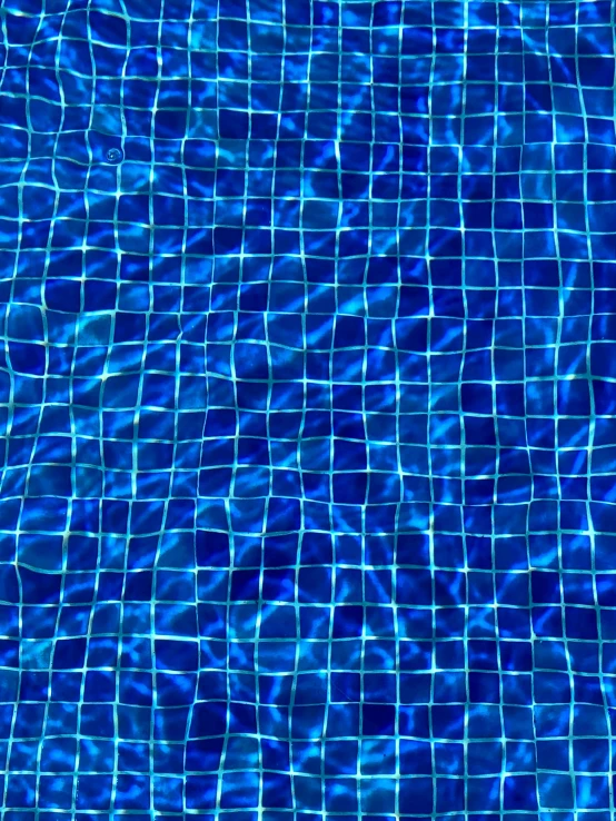 a blue water swimming pool in the middle of summer