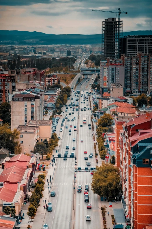 the city skyline shows many buildings and vehicles driving on the street