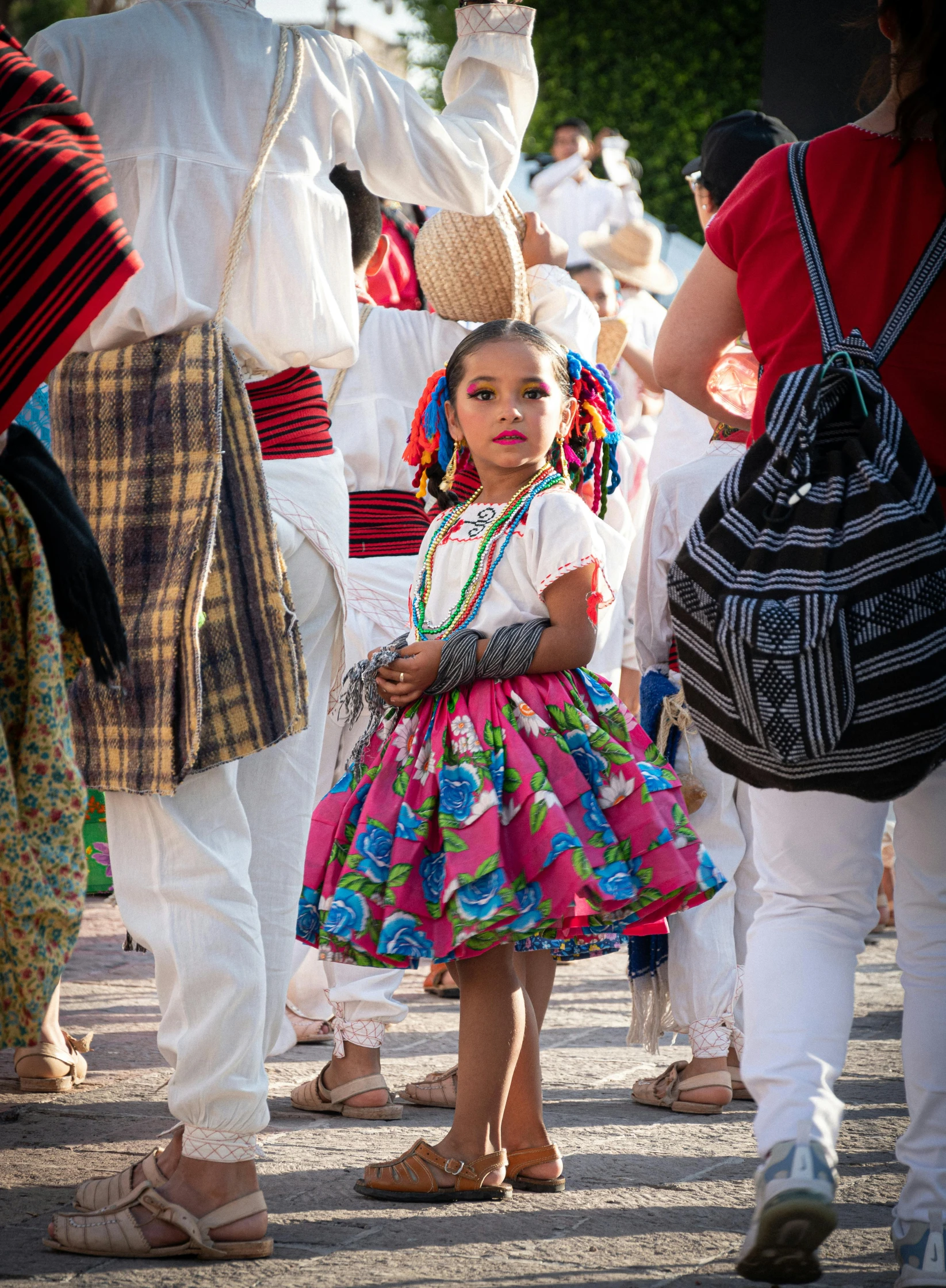 a  in a bright colorful dress is surrounded by some people