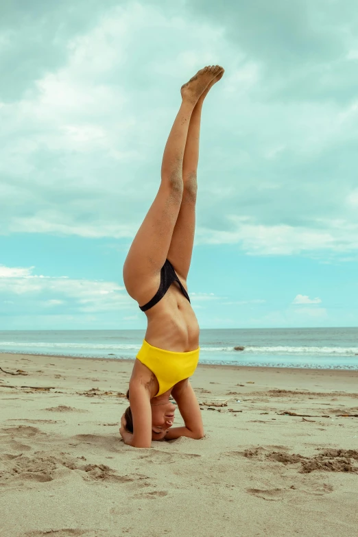 a woman in a bikini poses on a beach