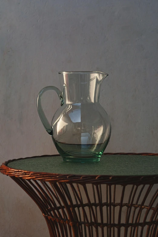 a water pitcher on top of a wicker table