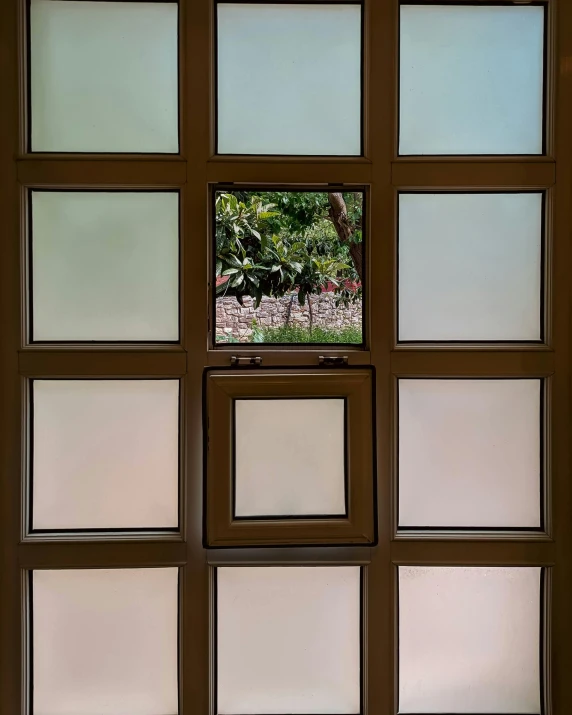 many small glass squares are stacked on the wall