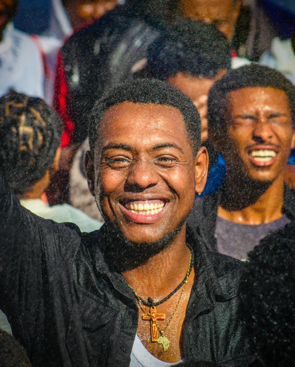 a smiling man in front of a crowd