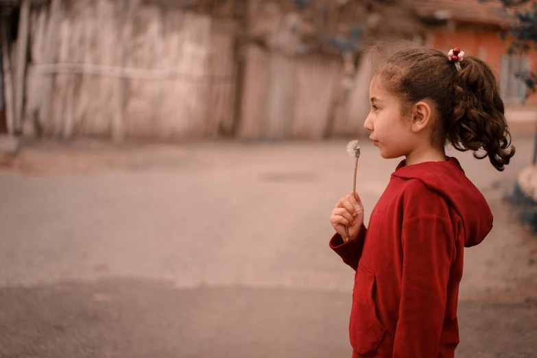 a girl holding a spoon in her hand