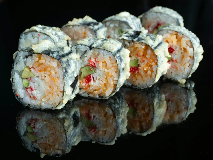 a sushi roll is shown with different types of toppings