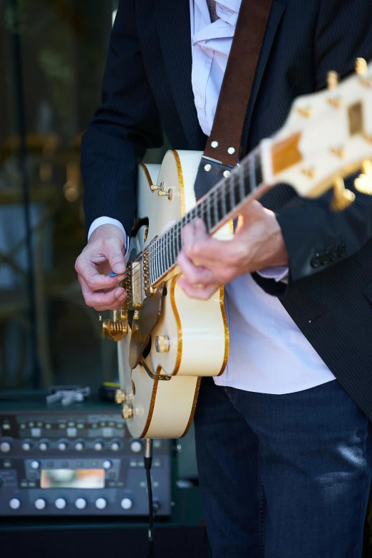 a man with a white guitar playing