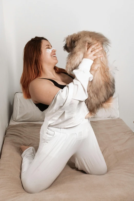 a woman holds a fluffy teddy bear in her arms