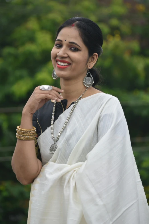 a woman with a necklace and earrings on