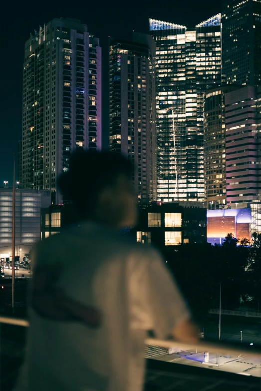 some tall buildings and a person by the water