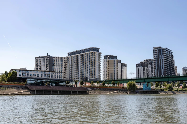 a bridge over a river leading to some buildings