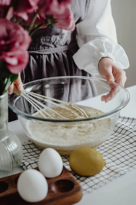 an image of a woman mixing soing in a bowl