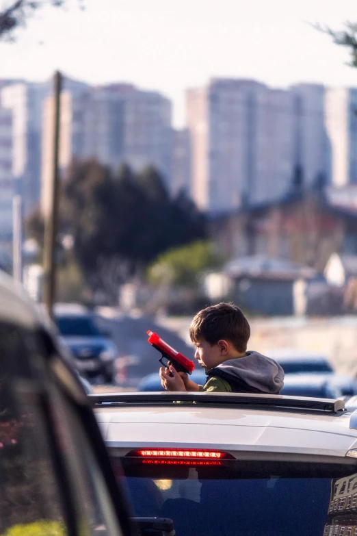 a small boy is sitting in the back of a car