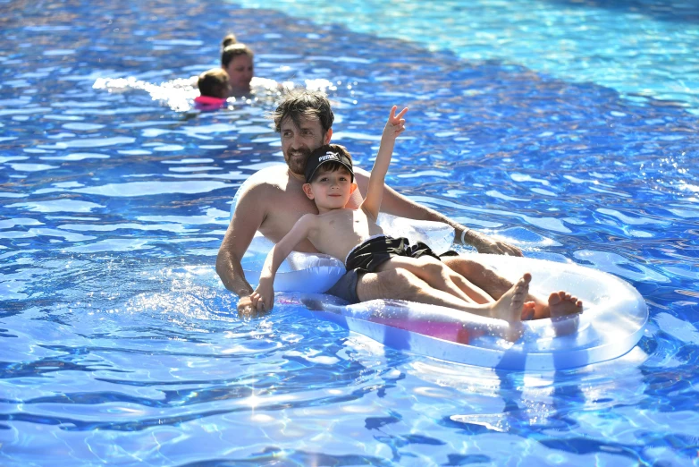 people floating on inflatable rafts in a swimming pool
