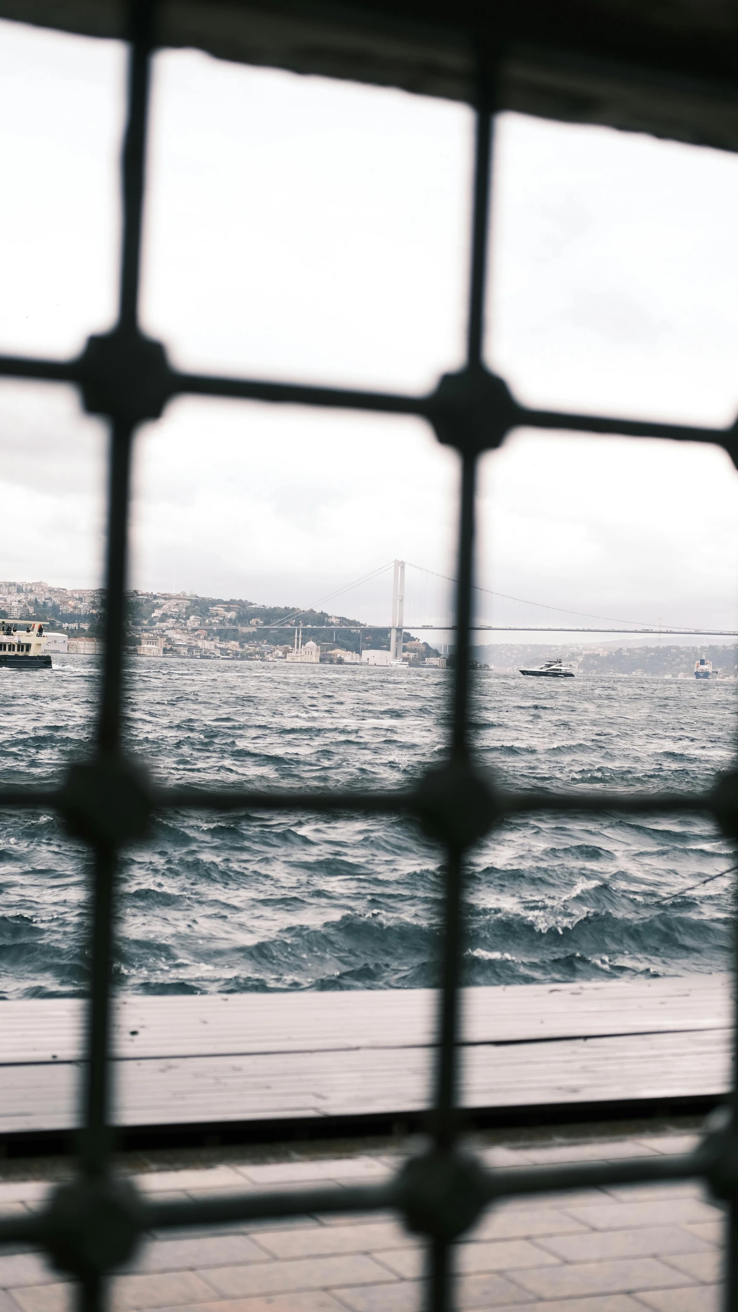 a person sitting on a bench looking out over the ocean