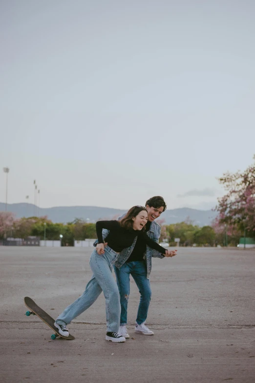 two young people are playing with their skateboard