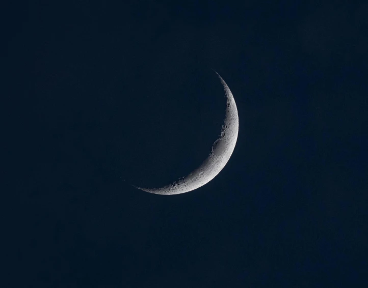 a half moon is seen in the sky