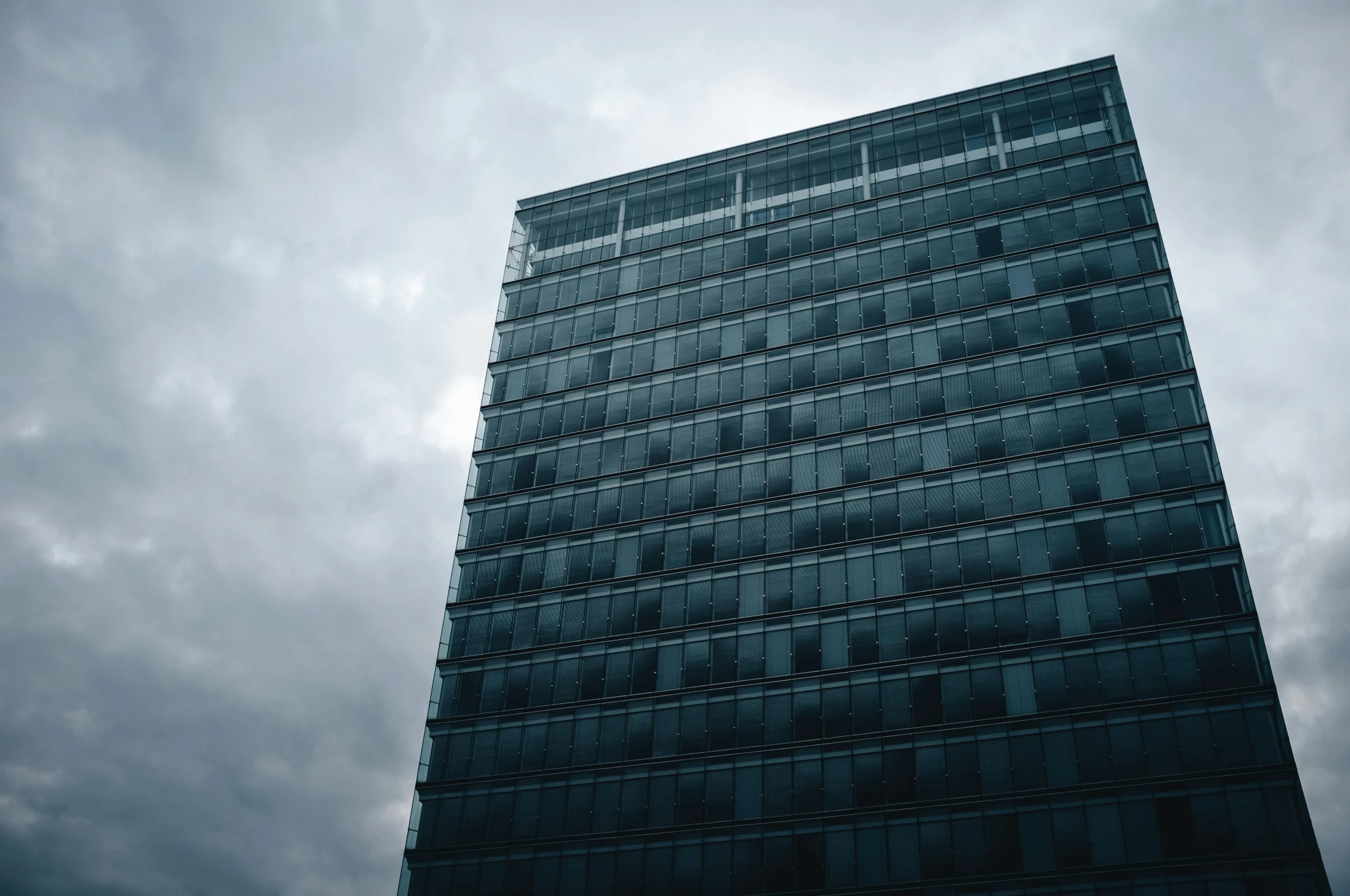 a tall building surrounded by dark clouds