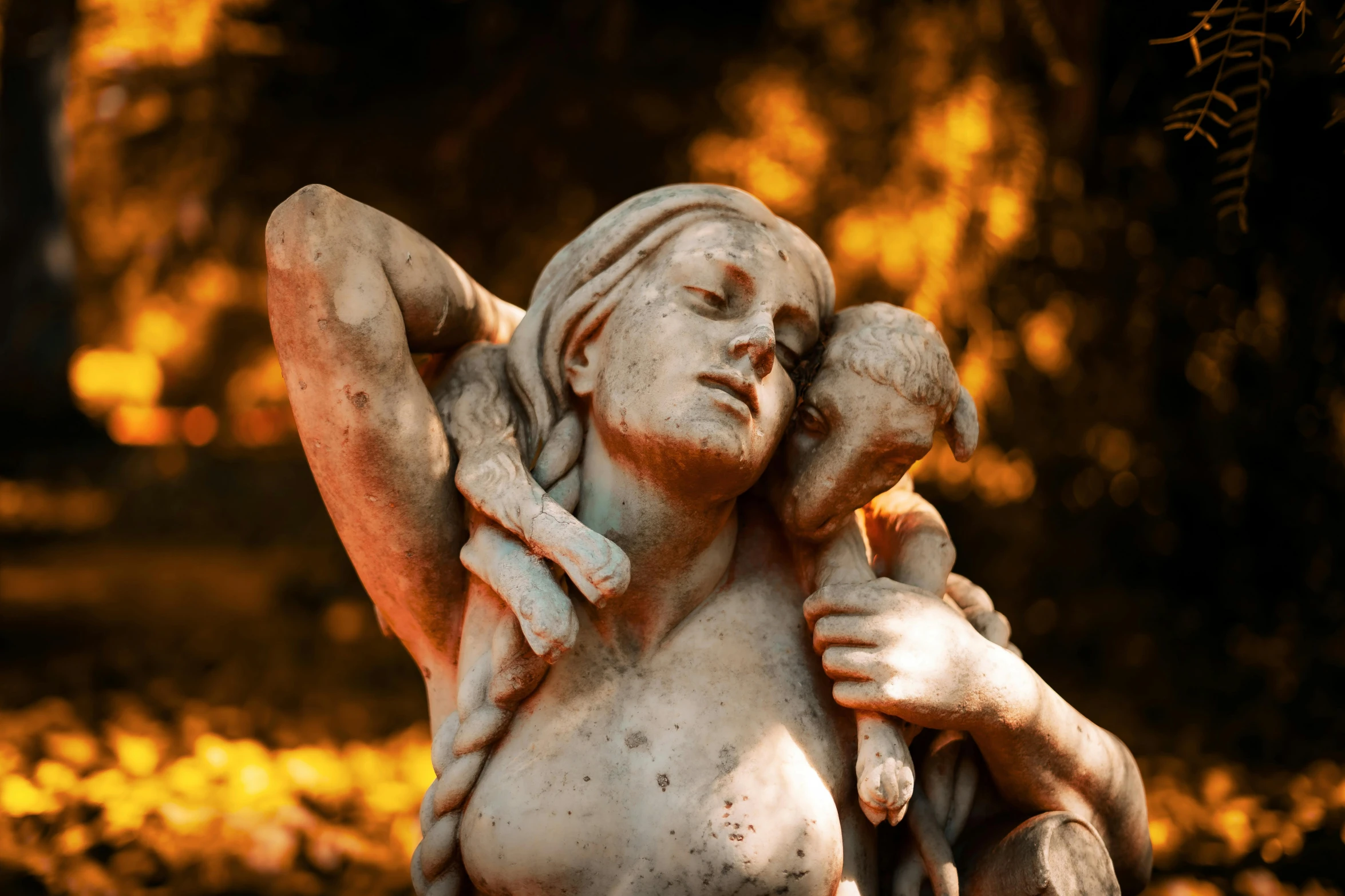 statued person holding small baby looking over his shoulder