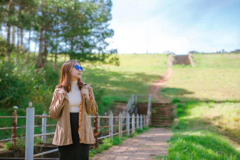 a woman looking up with a hat and coat on while standing outside