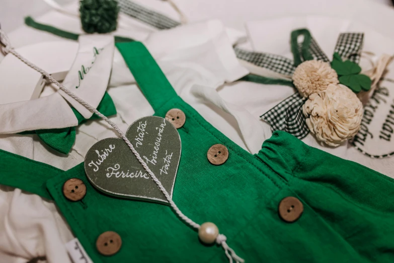 a green and white dress with ons on it