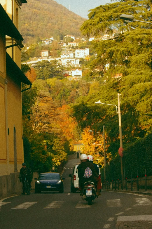 a person on a motorcycle driving down the street