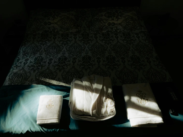 two books sit on the pillow in a dark room