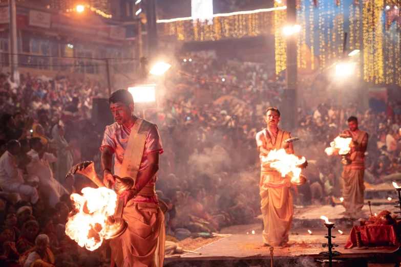 people watching performers perform on stage at night