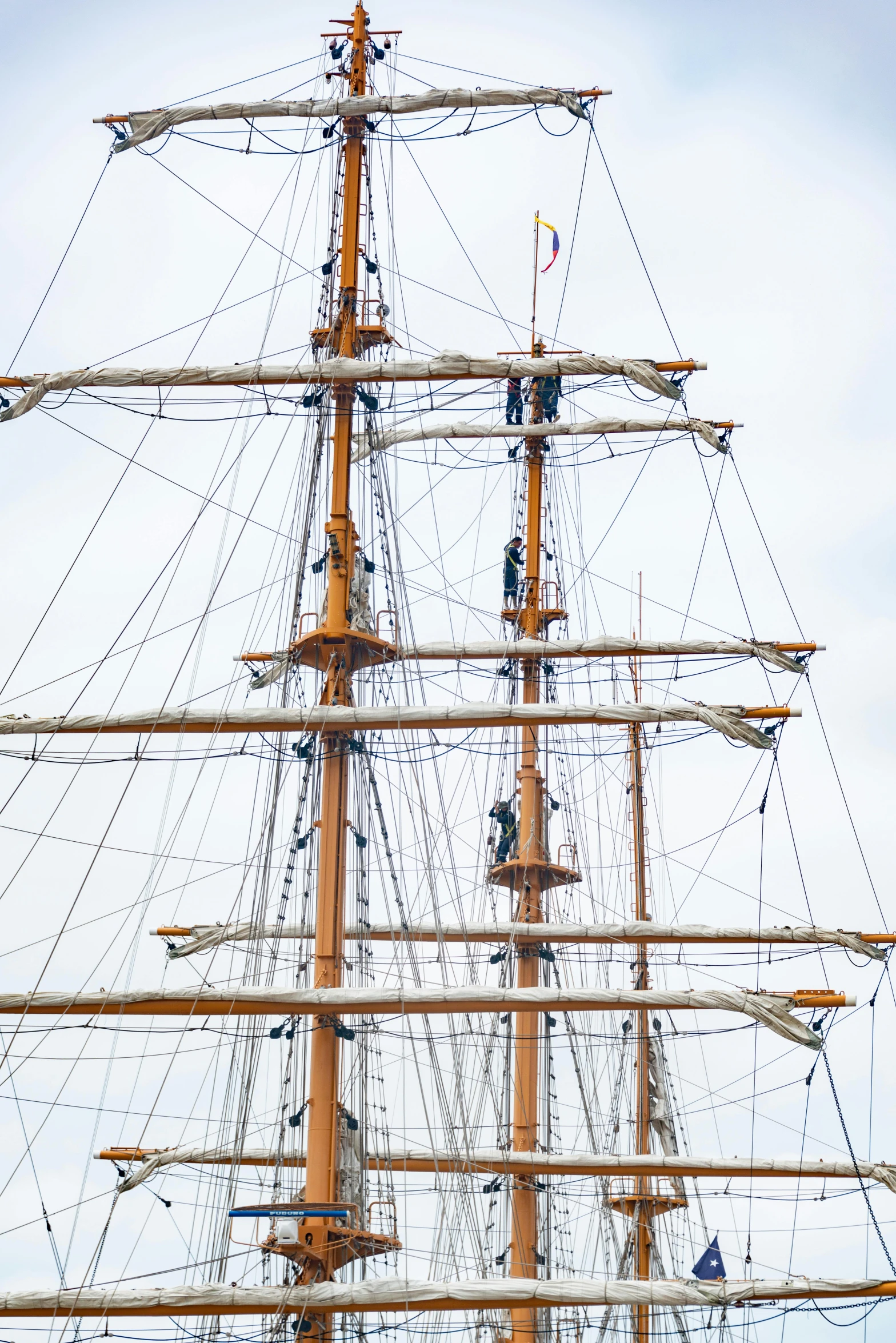 a sailboat with many sails floating in the ocean