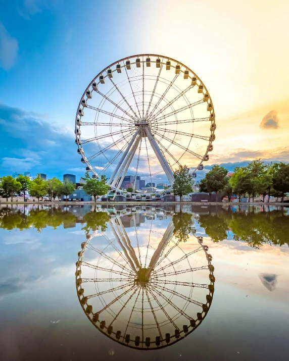 a large ferris wheel standing in the middle of a lake