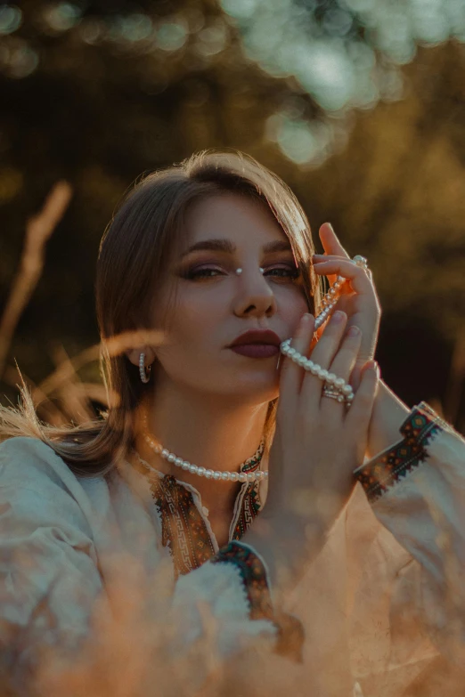 a woman with pearls is smoking a cigarette