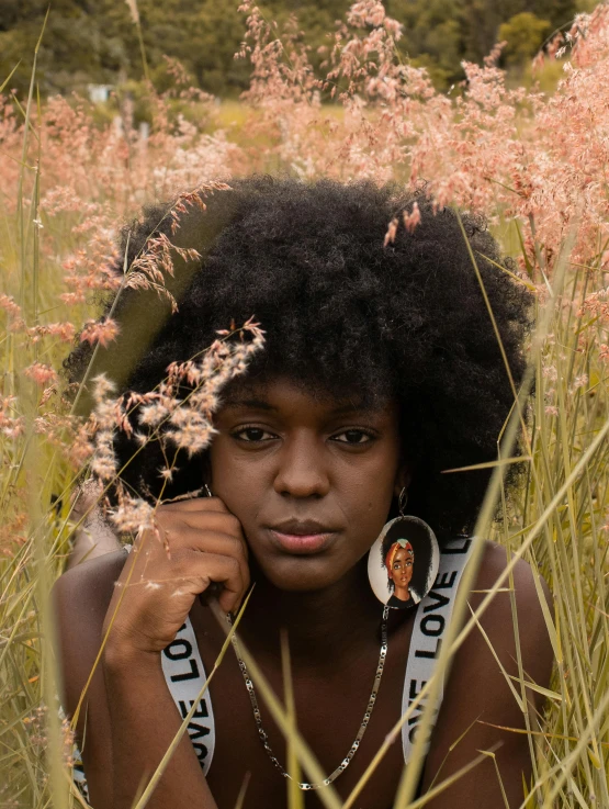 a young woman in a flowery field poses for a po