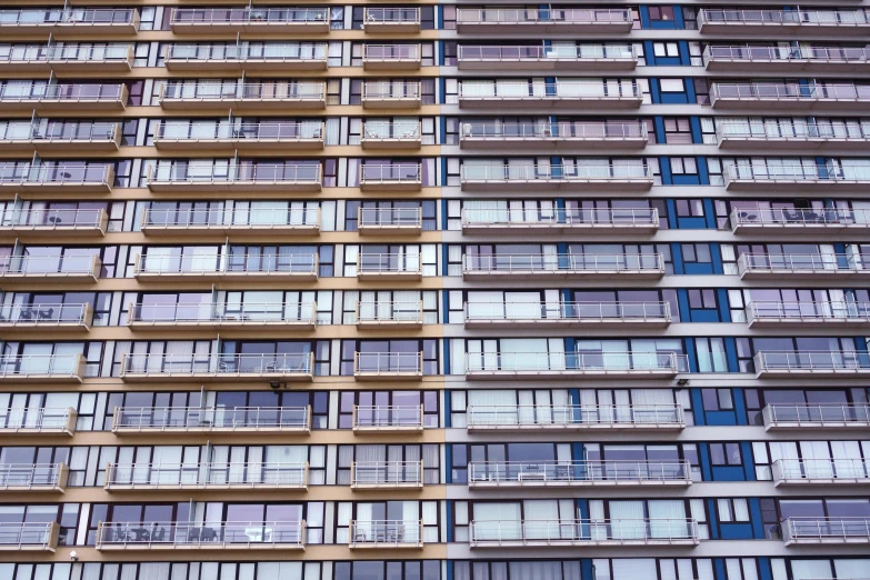 an older looking multi - level apartment building made of windows