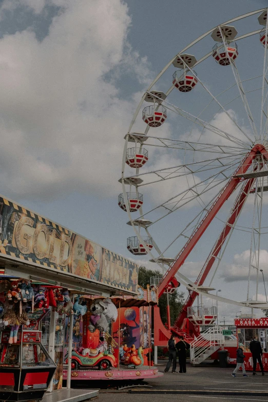 an amut park with rides, ferris wheels and a carnival on the pavement