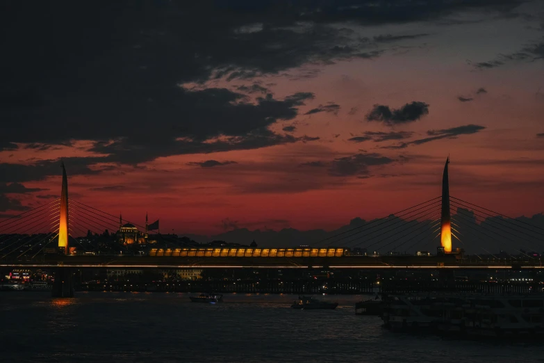 a very tall bridge with lights on at night