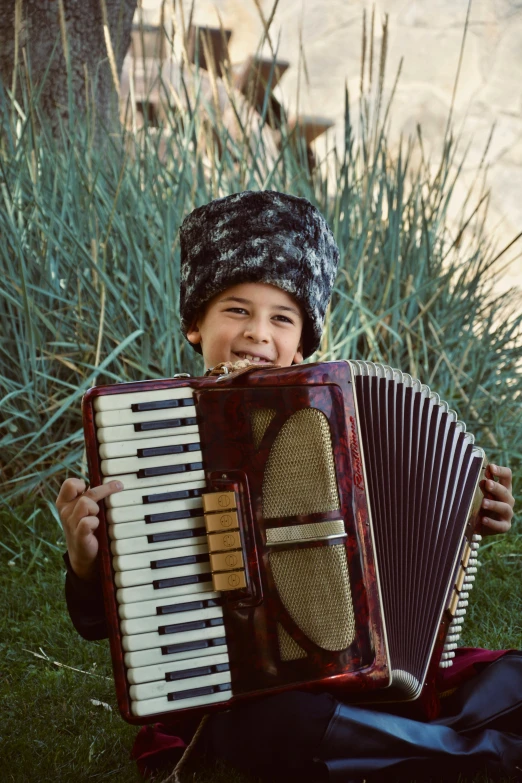 a  holding an accordion on the grass