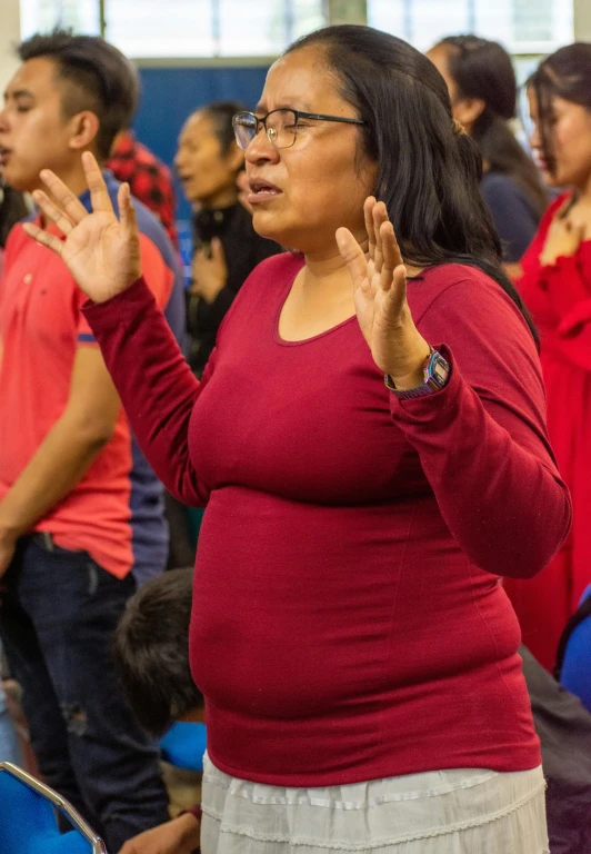 an obese woman is applauding with her hands together