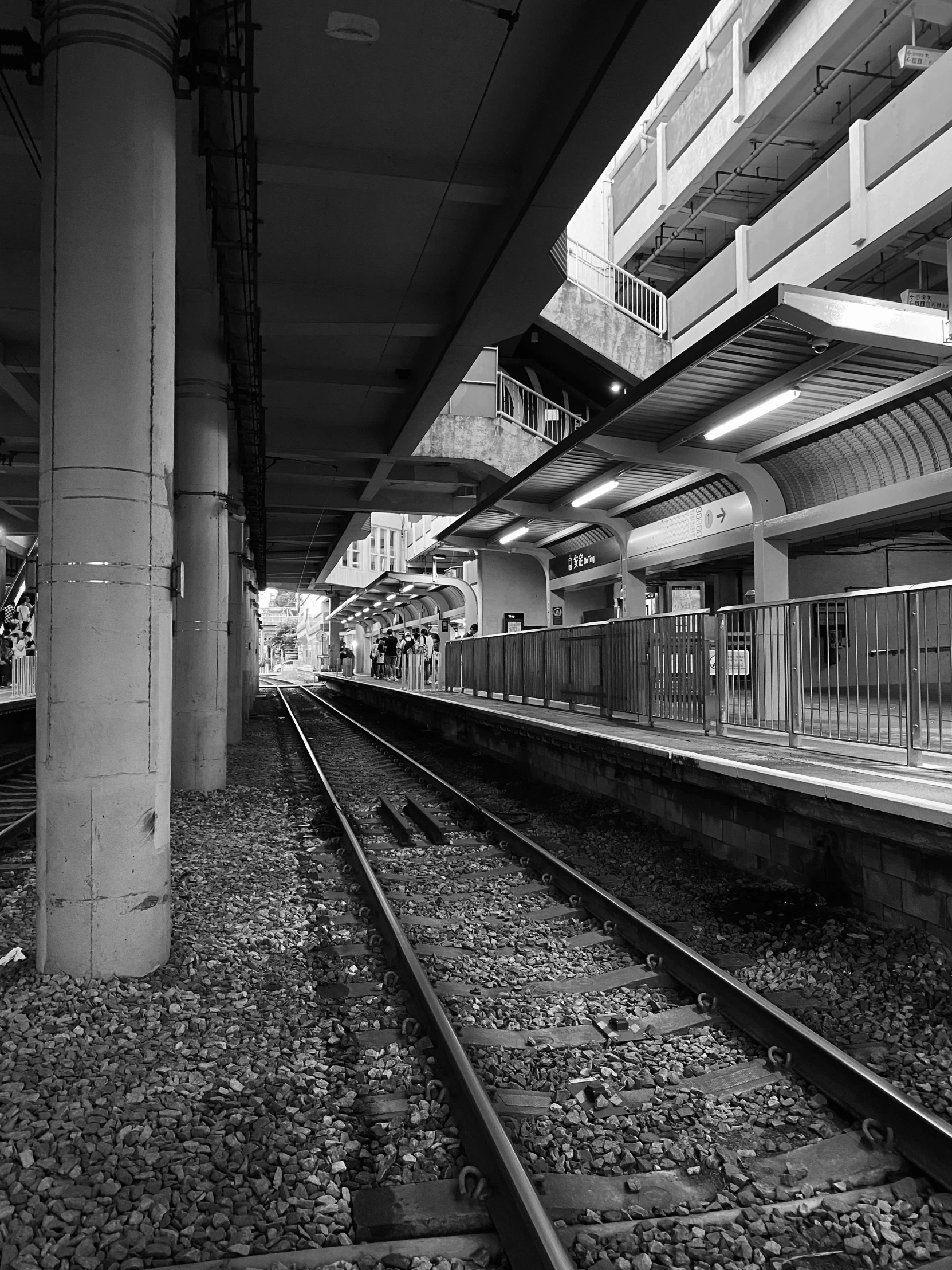 an empty train track near a tall building