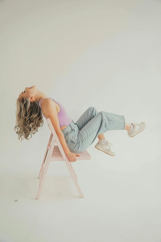 the young woman is sitting on the chair