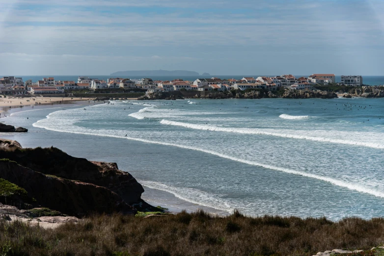 a po from the edge of a beach with surfboards in the water