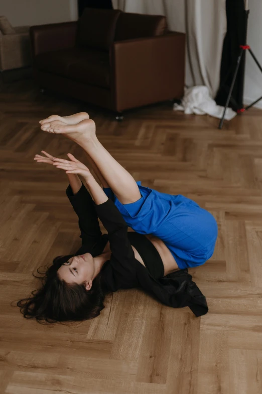 a woman is doing yoga exercises in a room