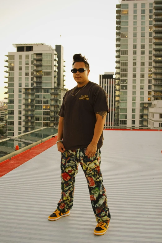 a person standing on a skateboard wearing a pair of colorful pants