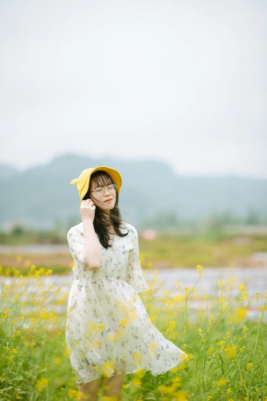 a woman standing in the middle of a field