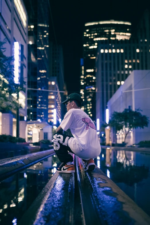 a  wearing white is skateboarding on the edge of the pool