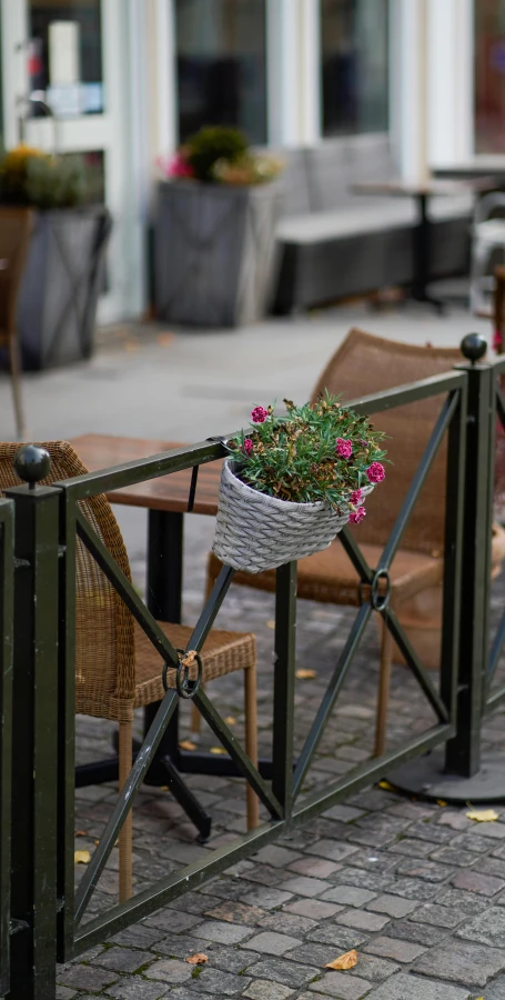 there is a small table with a flower pot attached